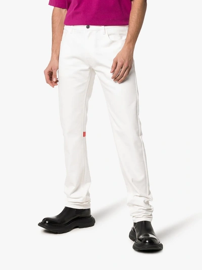 Shop Raf Simons Straight Leg Logo Patch Jeans In White