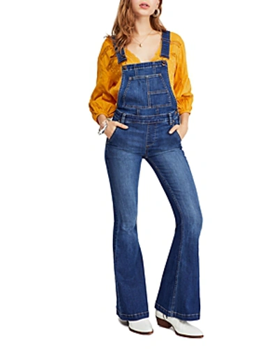 Shop Free People Carly Flared Denim Overalls In Blue