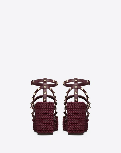 Shop Valentino Garavani Rockstud Ankle Strap Wedge Sandal 95 Mm In Ruby