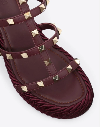 Shop Valentino Garavani Rockstud Ankle Strap Wedge Sandal 95 Mm In Ruby