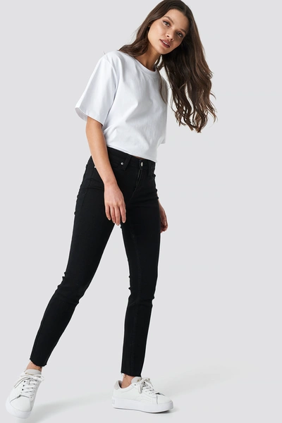 Shop Calvin Klein Super Skinny Ankle Jeans - Black In Jaelle Raw Hem