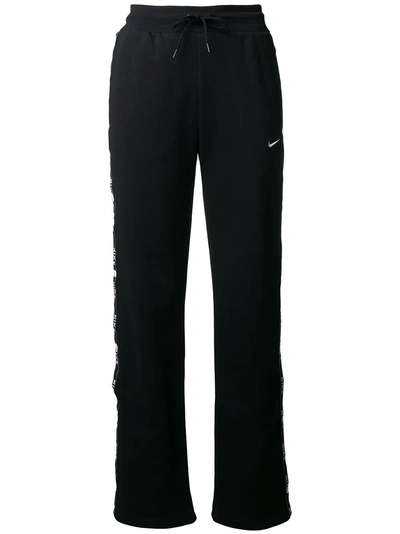Shop Nike Logo Tape Popper Trousers - Black