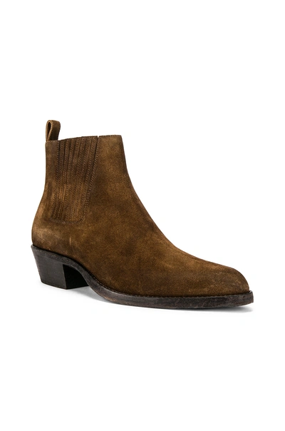 Shop Saint Laurent Dakota Boots In Land