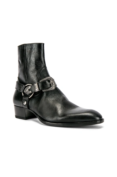 Shop Saint Laurent Wyatt Harness Boots In Black.