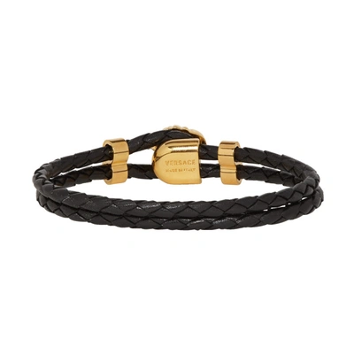 Shop Versace Black And Gold Leather Medusa Wrap Bracelet In D41o Black/