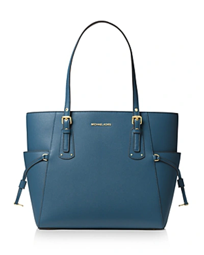 Shop Michael Michael Kors Voyager East West Leather Tote In Dk Chambray/gold