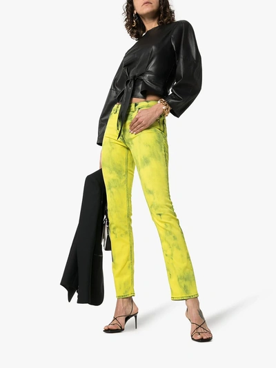 Shop Versace Acid Wash Logo Label Skinny Jeans In 115 - Yellow
