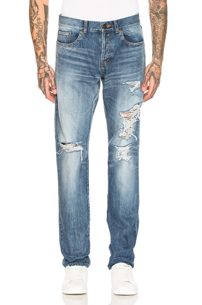 Shop Saint Laurent Distressed Skinny Jeans In Denim Light In Faded Medium Blue
