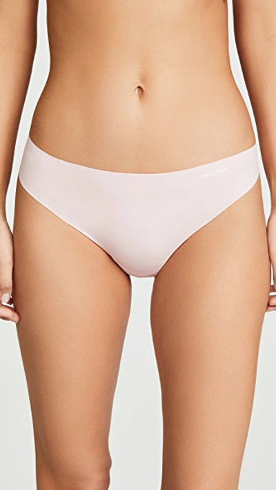 Shop Calvin Klein Underwear Invisibles Thong In Peach Glow