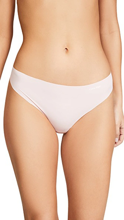 Shop Calvin Klein Underwear Invisibles Thong In Peach Glow