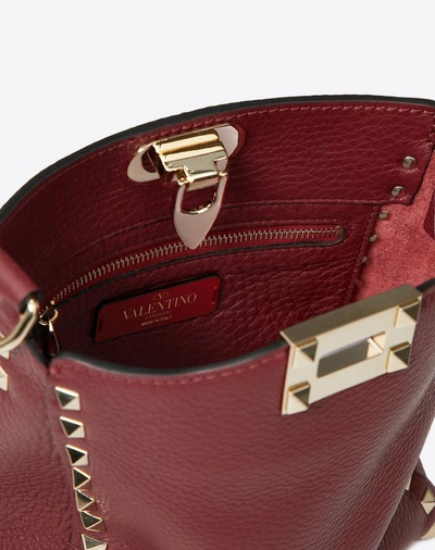 Shop Valentino Garavani Mini Rockstud Grainy Leather Hobo Bag In Cherry