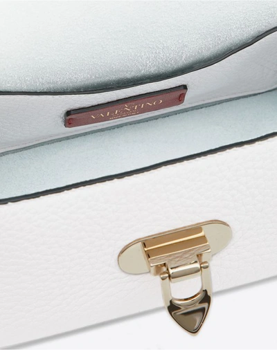 Shop Valentino Garavani Mini Rockstud Grainy Leather Crossbody Bag In White