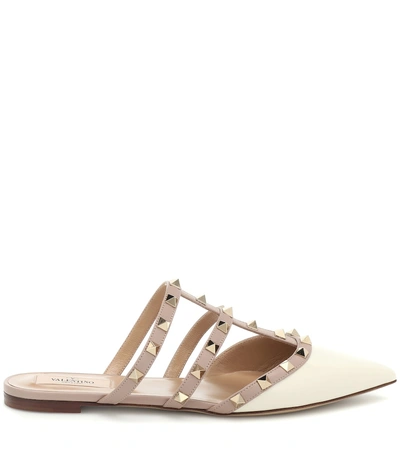 Shop Valentino Rockstud Patent Leather Slippers In White