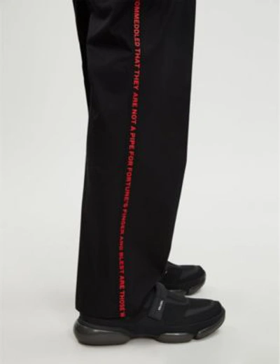 Shop Burberry Text-embroidered Regular-fit Cotton Trousers In Black