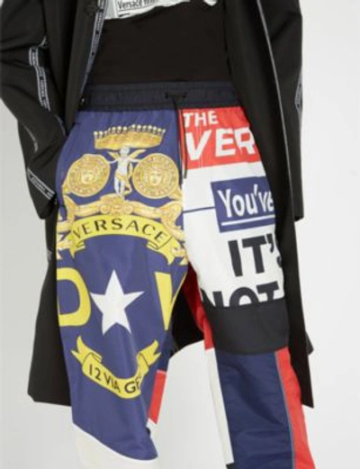 Shop Versace News-print Shell Jogging Bottoms In White Red Blue