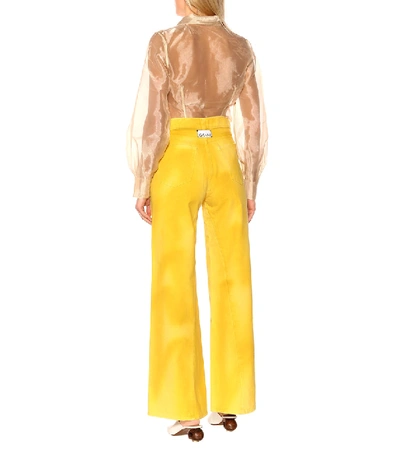 Shop Ganni High-waisted Flared Jeans In Yellow