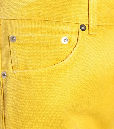 Shop Ganni High-waisted Flared Jeans In Yellow