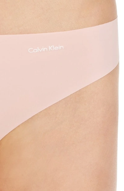 Shop Calvin Klein Invisibles Thong In Peach Glow