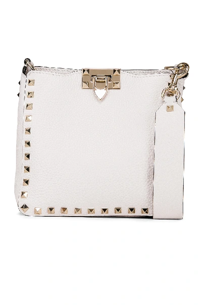 Shop Valentino Rockstud Mini Hobo Bag In Bianco Ottico