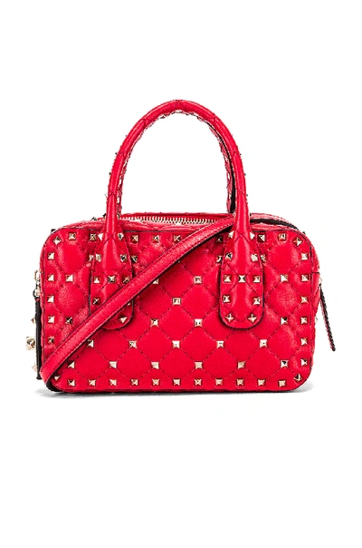 Shop Valentino Rockstud Spike Small Duffle Bag In Red In Rouge