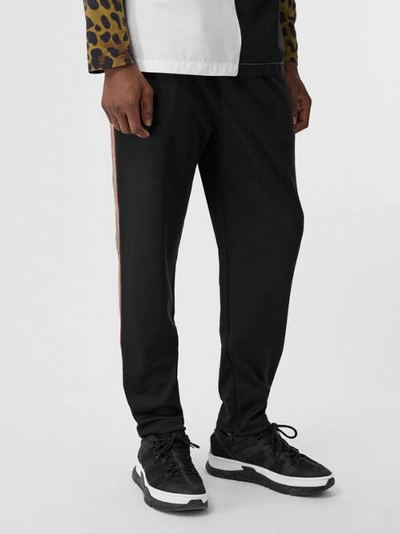 Shop Burberry Icon Stripe Detail Jersey Trackpants In Black