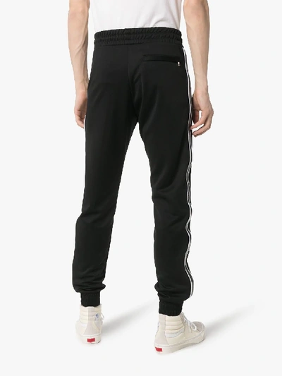 Shop Amiri Zip Pocket Logo Embroidered Track Pants In Black