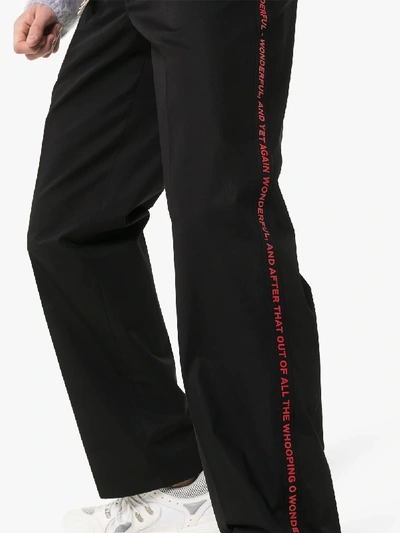 Shop Burberry Script Cotton Trousers In Black