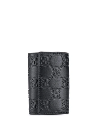 Shop Gucci Signature Embossed Key Holder In Black