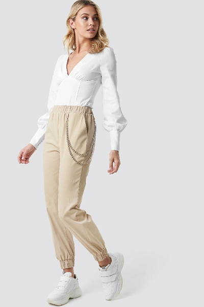 Shop Anna Nooshin X Na-kd Chain Detailed Puffy Trousers Beige In Brown