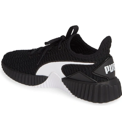 Shop Puma Defy Sneaker In Black/ White
