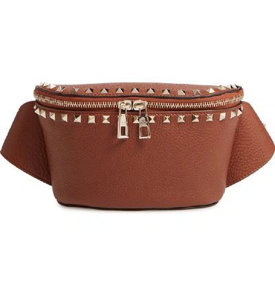 Shop Valentino Rockstud Belt Bag In Bright Cognac