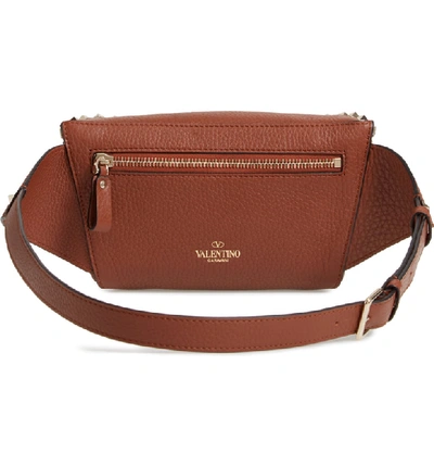 Shop Valentino Rockstud Belt Bag In Bright Cognac