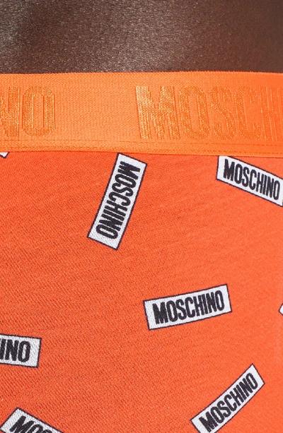 Shop Moschino Allover Tag Trunks In Orange