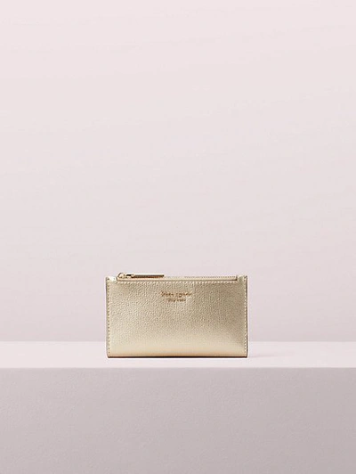 Shop Kate Spade Sylvia Small Slim Bifold Wallet In Pale Gold