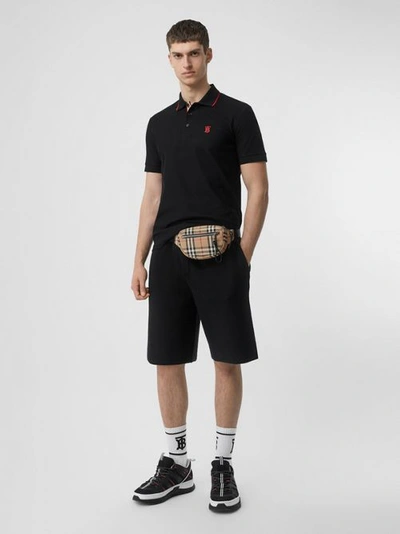 Shop Burberry Icon Stripe Placket Cotton Piqué Polo Shirt In Black