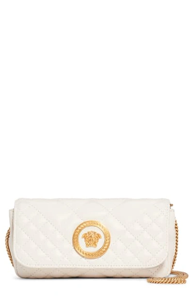 Shop Versace Small Tribute Small Quilted Crossbody Bag - Ivory In Off White/ Oro Tribute