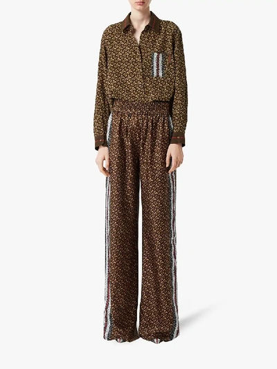 Shop Burberry Monogram Print Trousers In Brown