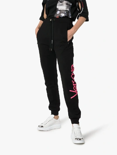 Shop Versace Logo Print Cotton Sweatpants In Black