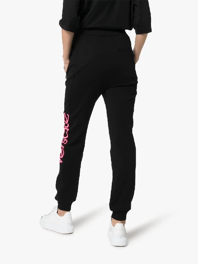 Shop Versace Logo Print Cotton Sweatpants In Black