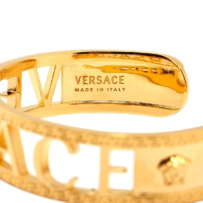 Shop Versace Logo Cuff Bracelet In Gold