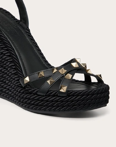 Shop Valentino Garavani Rockstud Calfskin Ankle Strap Wedge Sandal 95 Mm In Black
