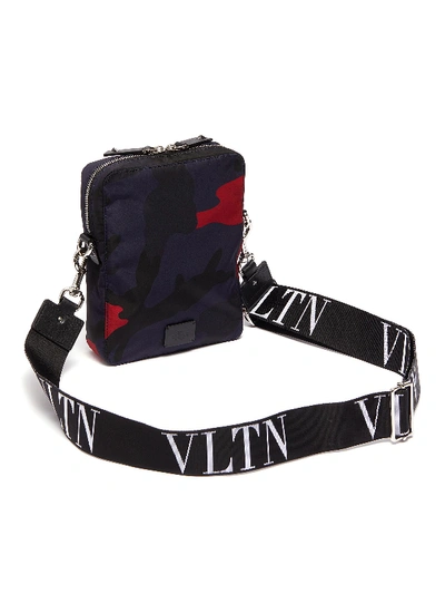 Shop Valentino 'vltn' Logo Shoulder Strap Camouflage Print Crossbody Bag In Dark Blue