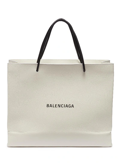 Shop Balenciaga 'east-west' Logo Print Medium Leather Shopping Tote Bag In White