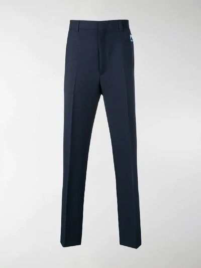 Shop Prada Logo Patch Tailored Trousers In Blue