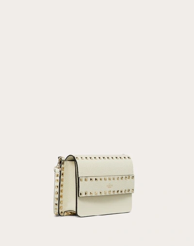 Shop Valentino Garavani Small Rockstud Grainy Leather Crossbody Bag In Light Ivory