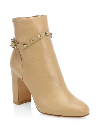 Shop Valentino Rockstud Pebbled Leather Ankle Booties In Camel