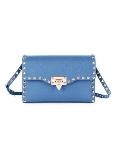 Shop Valentino Garavani Small Rockstud Leather Crossbody Bag In Blue