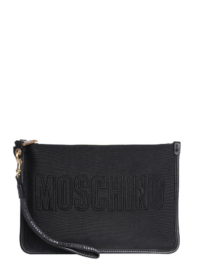 Shop Moschino Logo Embossed Zipped Clutch Bag In Black