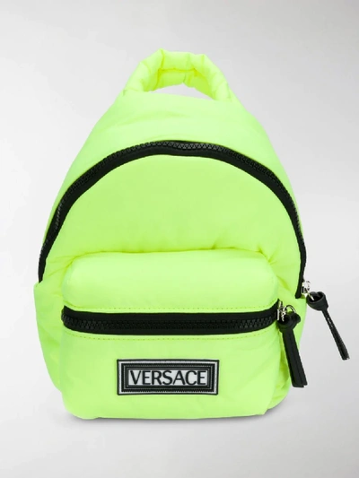 Shop Versace Mini Crossbody Backpack In Yellow