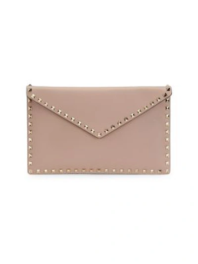 Shop Valentino Garavani Large Rockstud Leather Clutch In Poudre